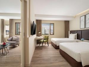 Postel nebo postele na pokoji v ubytování AIHO Hotel Medan
