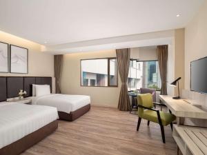 Postel nebo postele na pokoji v ubytování AIHO Hotel Medan