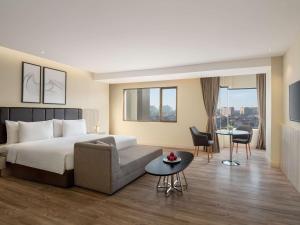 Postel nebo postele na pokoji v ubytování AIHO Hotel Medan