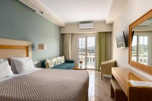 a hotel room with a bed and a couch at Odysseus Hotel in Paleokastritsa +37 photos