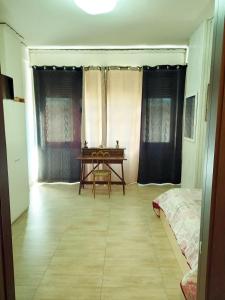um quarto com uma mesa e uma cama em Badia em Aversa