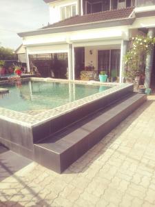 a swimming pool in front of a house at Villa FRANCOISE in Pereybere