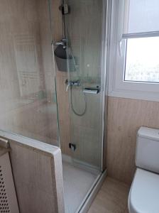 a bathroom with a glass shower with a toilet at ATeRIAN ONDAR GAIN in Zarautz