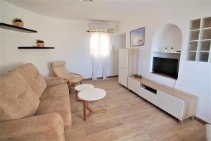 a living room with a couch and a tv at A0831 in Calpe