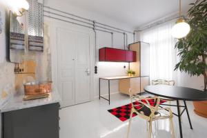 a kitchen with a table and a refrigerator at Trilogy Experimental in Thessaloniki