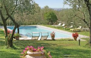 a swimming pool with chairs and flowers in a yard at Awesome Home In Buggiano Pt With Outdoor Swimming Pool in Borgo a Buggiano