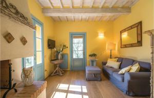 ボルゴ・ア・ブッジャーノにあるBeautiful Home In Buggiano Pt With 3 Bedrooms, Private Swimming Pool And Outdoor Swimming Poolの青いソファと黄色の壁が特徴のリビングルーム