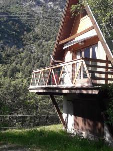 a house with a balcony on the side of it at chalets montagnard in Jausiers