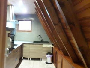 a small kitchen with a sink and a counter at chalets montagnard in Jausiers