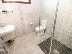 a bathroom with a toilet and a glass shower at Foxglove Lodge in Saltburn-by-the-Sea +16 photos