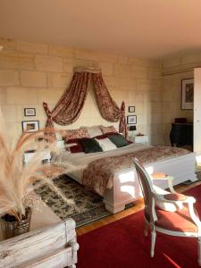 um quarto com uma cama de dossel grande em Chambre Merlot, piscine et spa, proche St Emilion em Lugon et l’Ile du Carney