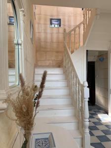 uma escada numa casa com um vaso de flores em Chambre Merlot, piscine et spa, proche St Emilion em Lugon et l’Ile du Carney