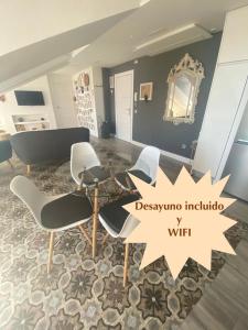 a room with chairs and a table and a mirror at Alojamiento Museo Carmelitano Alba de Tormes in Alba de Tormes