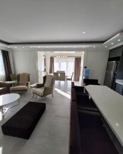 a living room with couches and a dining room at BEGONVİL VİLLA in Belek +46 photos