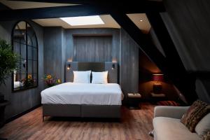 a bedroom with a bed and a couch at City Center Lodge Utrecht in Utrecht