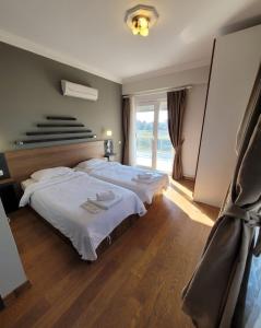 a bedroom with two beds and a large window at BEGONVİL VİLLA in Belek +34 photos