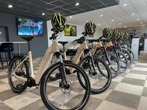 a row of bikes parked in a store with helmets on them at ARGENTA Living 16 in Künzell