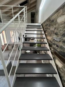 a staircase in a loft with a stone wall at Blue Diamond Como in Como