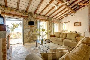a living room with a couch and a table at Scirocco & Folitsa Villas in Agnítsini