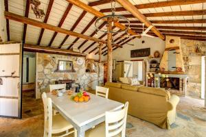 a living room with a table and a couch at Scirocco & Folitsa Villas in Agnítsini