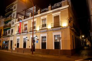 a building on a city street at night at Noches en Triana in Seville