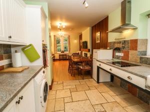 a kitchen with a sink and a dishwasher at Holly Lodge in Appleby