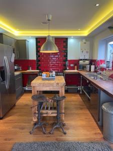 a kitchen with a wooden table and a refrigerator at The Town House - Newquay in Newquay