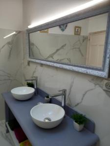 a bathroom with a sink and a mirror on a counter at L'OCCITANE appartement climatisé centre ville in Limoux +14 photos