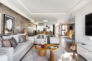 a living room with a couch and a table at Villa Alexandra by Sweett in Cannes