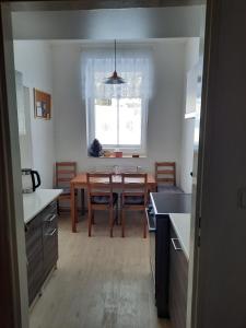 una cucina con tavolo e una sala da pranzo di apartmán Kořen se saunou , Kořenov Jizerské hory a Kořenov