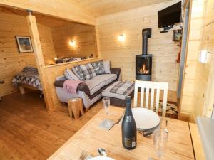 a living room with a couch and a fireplace at Otters Holt in Darlington