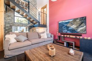 a living room with a couch and a tv at Chalet Azobe Morzine - by EMERALD STAY in Montriond