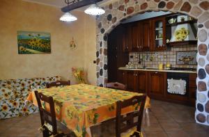 a kitchen with a table with a yellow tablecloth on it at Appartamento Girasole in Santa Domenica