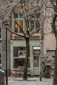 a tree in front of a store in the snow at Hotel Urban Dreams in Antwerp