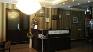 a hotel lobby with a reception desk and a chandelier at Hotel Smarald in Eforie Nord