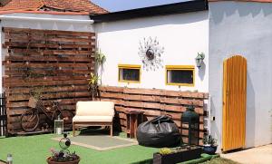 a backyard with a wooden wall and a chair at Herama House in Vila Nova de Gaia