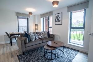 a living room with a couch and a table at Kelham Gate Central Apartments Near Peaks Crucible Utilita Arena in Sheffield