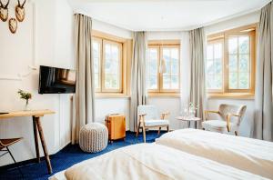 TV a/nebo společenská místnost v ubytování Alpenrose Bayrischzell Hotel