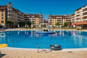 a large swimming pool in a city with buildings at Menada Royal Sun Apartments in Sunny Beach