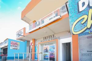 a building with a balcony on top of it at OYO Hotel Plaza Las Torres, Cabo San Lucas in Cabo San Lucas