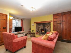 a living room with two chairs and a fireplace at 2 Lime Street in Bridgwater