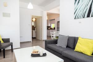 a living room with a couch and a table at Protaras View Villas in Protaras