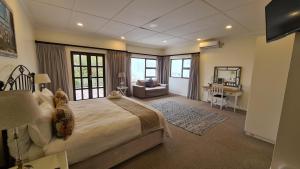 una camera da letto con un letto grande e una scrivania di Hathaway Guest House a East London Altre 67 foto