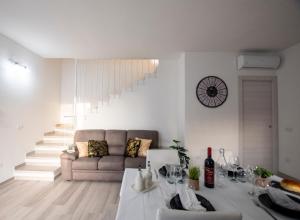 a living room with a couch and a table at Villa Orchidea in Valledoria