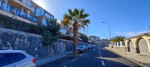 a street with cars parked next to a stone wall at Villa La Tagora with Private Pool in Adeje