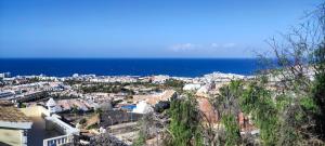 a view of a city with the ocean in the background at Villa La Tagora with Private Pool in Adeje