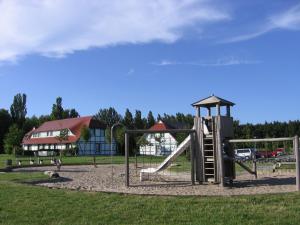 a playground with a slide in a park at Ferienparadies Rugana A09 in Kreptitz