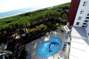 an indoor swimming pool with a dolphin in the water at Giulivo Hotel & Village in Baia Domizia