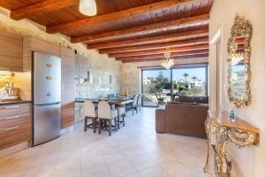 an open kitchen and dining room with a dining table at SpiliaInn in Spiliá