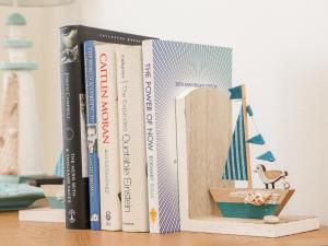 a row of books sitting on a shelf at Ocean View in Praa Sands